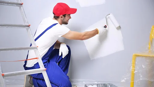 Painters applying a fresh coat of paint to an apartment wall in Dubai